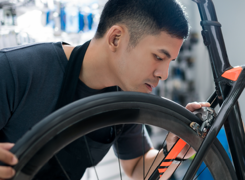 man fixing bicycle